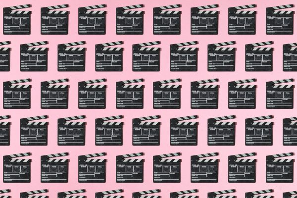 Startups Weekly: Stay tuned for the Rippling espionage movie Wooden old movie clapperboard pattern with hard shadow on pink background. Concept of film industry, cinema, entertainment, and Hollywood.
